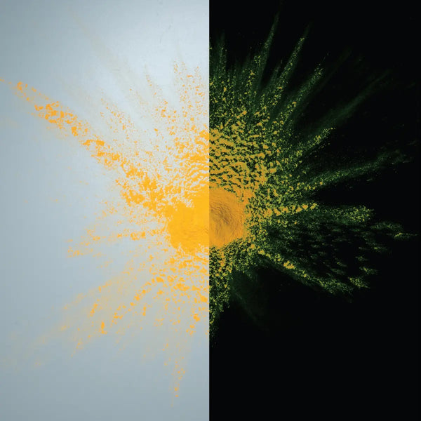 Glow-in-the-dark Light Orange to Yellow pigment powder bursting in a fine neon spray—ideal for safety markings, party décor, halloween pumpkin and professional installations requiring long-lasting, high-contrast glow