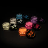 Top-down spread of six neon pigment powders—green, blue, yellow, orange, purple, cyan—ideal for mixing into acrylics, clay, fabrics, and resin crafts for vibrant, best-selling glow effects