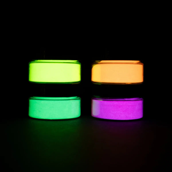 Static pyramid of four blacklight-reactive acrylic paint jars on a dark surface—perfect for bold, high-contrast UV art creations.