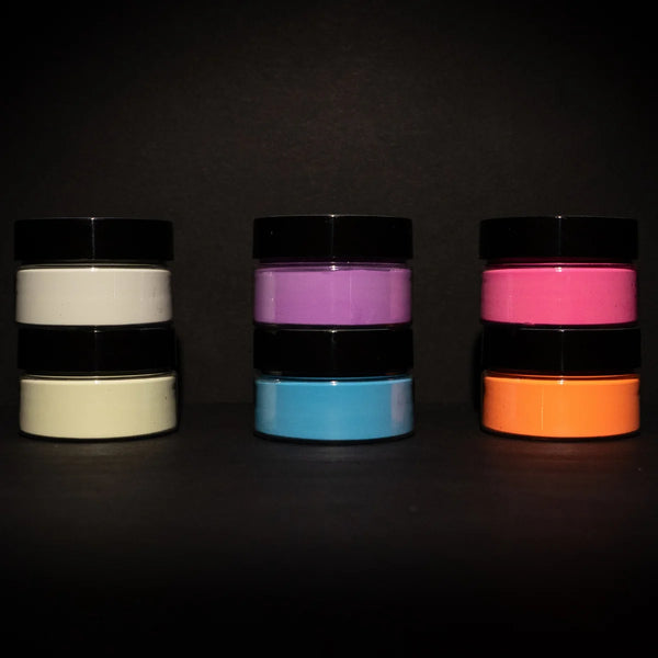 Static pyramid of six blacklight-reactive acrylic paint jars on a dark backdrop—perfect for creating bold, high-contrast UV art