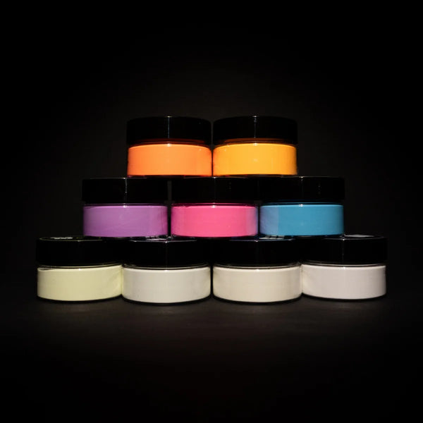 Static pyramid of 9 blacklight-reactive acrylic paint jars showcasing the best UV-charged hues for DIY projects