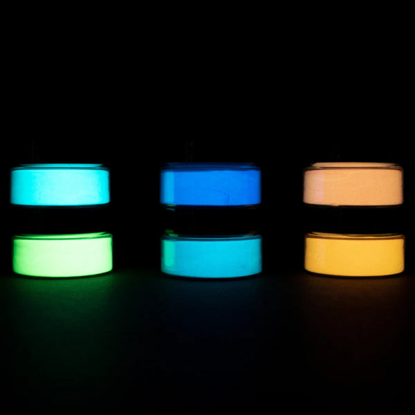 Dark-room shot of a six-jar glow-in-the-dark paint pyramid—showcasing intense, enduring glow for night-time DIY projects