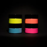 Dark-room shot of a four-jar glow-in-the-dark paint pyramid—showcasing the brightest, long-lasting luminescence for night-time DIY