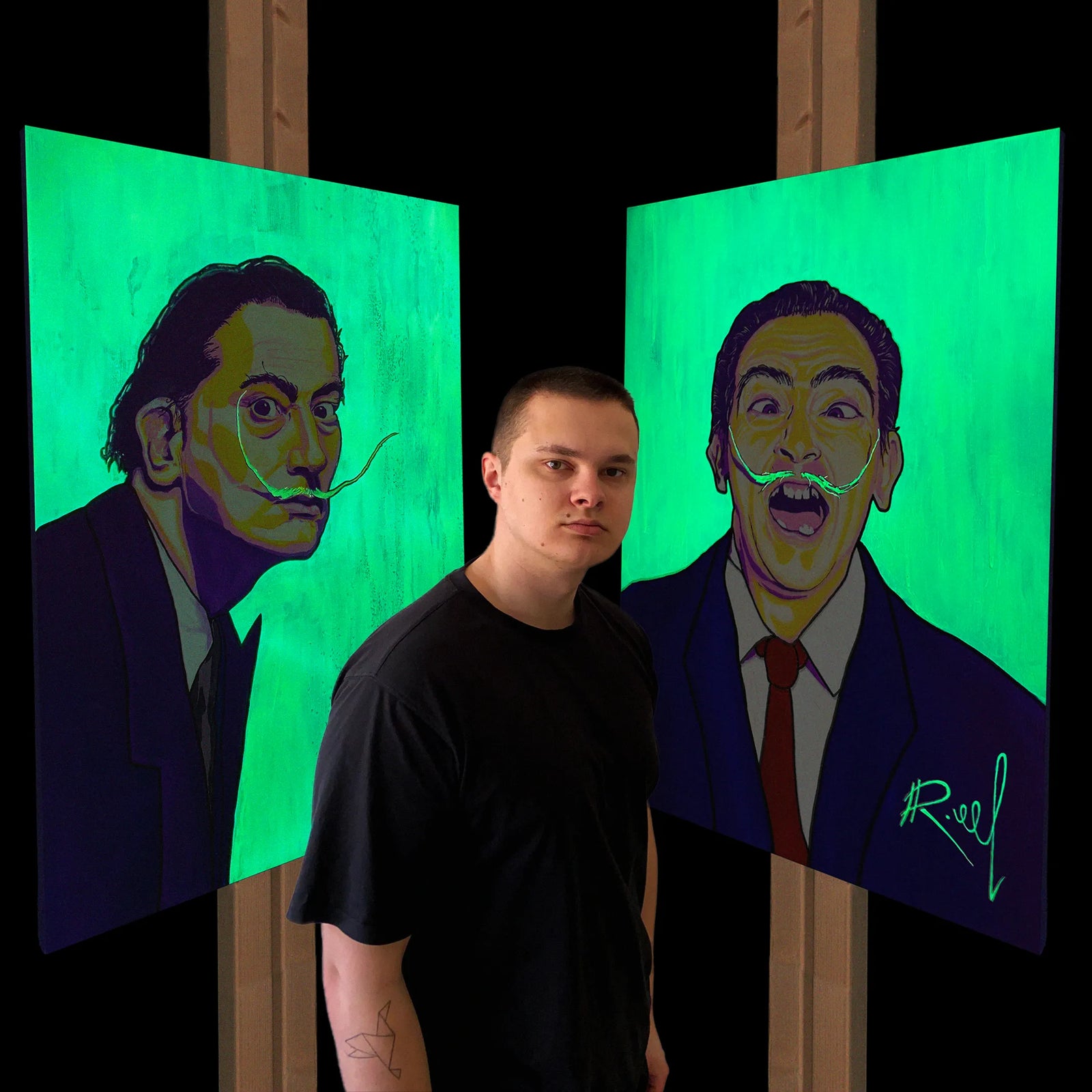 an artist standing next to a 2 original pieces of salvador dali paintings in glow in the dark