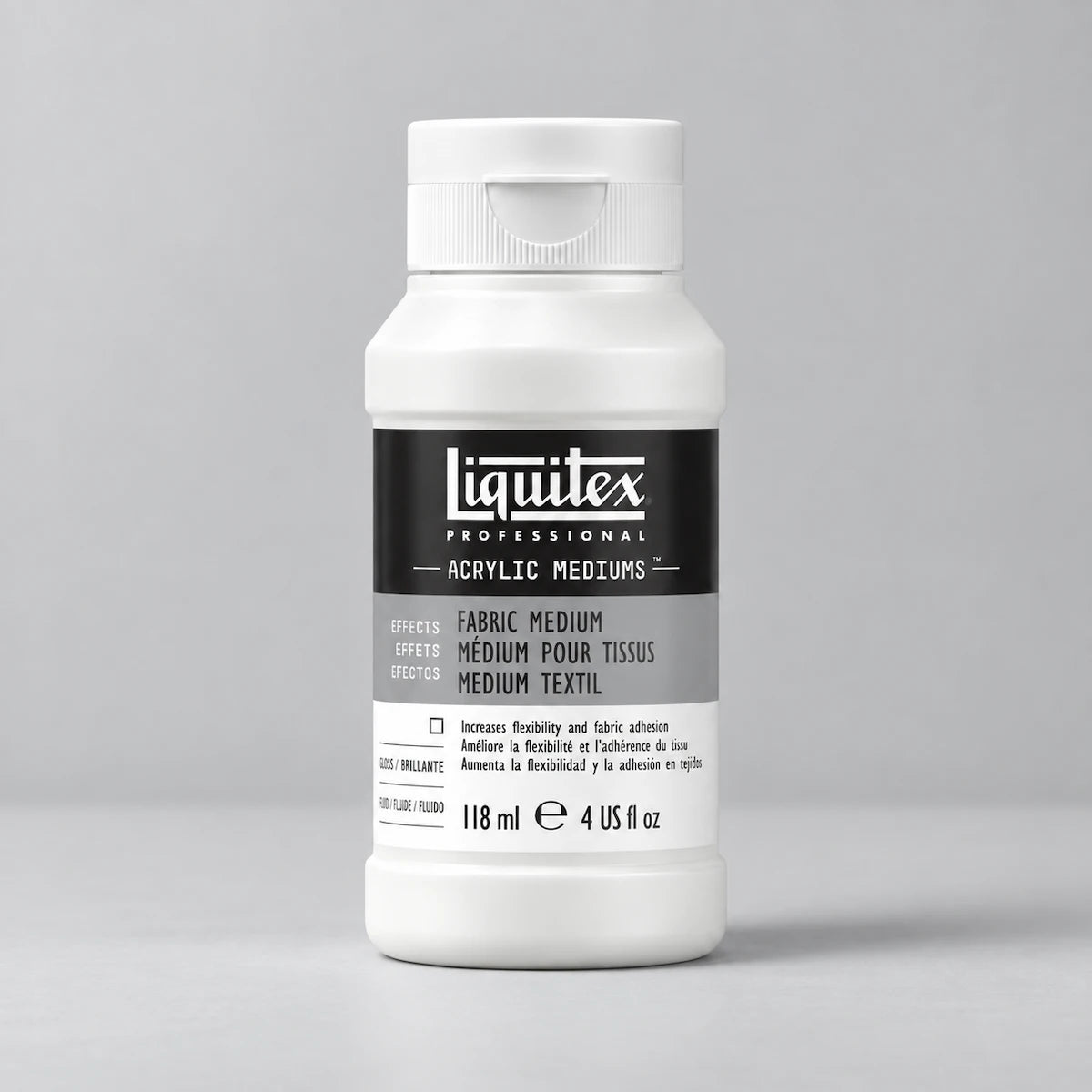 A white plastic bottle of Liguitex Professional Acrylic Mediums, specifically Fabric Medium, on a neutral light gray background.