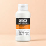 A bottle of Liquitex Professional Matte Varnish acrylic medium, shown on a solid peach-colored background. The bottle is white with a black and orange label.