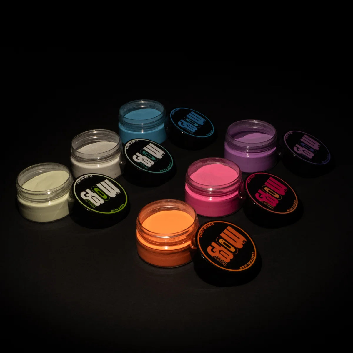 Top-down spread of six neon pigment powders—green, blue, yellow, orange, purple, cyan—ideal for mixing into acrylics, clay, fabrics, and resin crafts for vibrant, best-selling glow effects