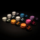 Top-down spread of 9 open phosphorescent paint jars revealing their brightest, long-lasting colors for resin, clay, and canvas.