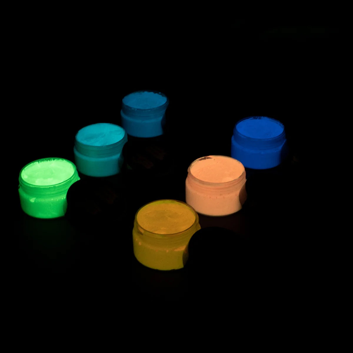 Charged strontium aluminate glow in the dark acrylic paint in six jars arranged neatly—delivering the brightest, long-lasting glow under UV or sunlight
